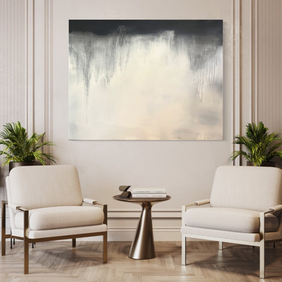 Abstract black and white oil painting #13 by Laurie Rubell displayed above two cream chairs in a contemporary interior